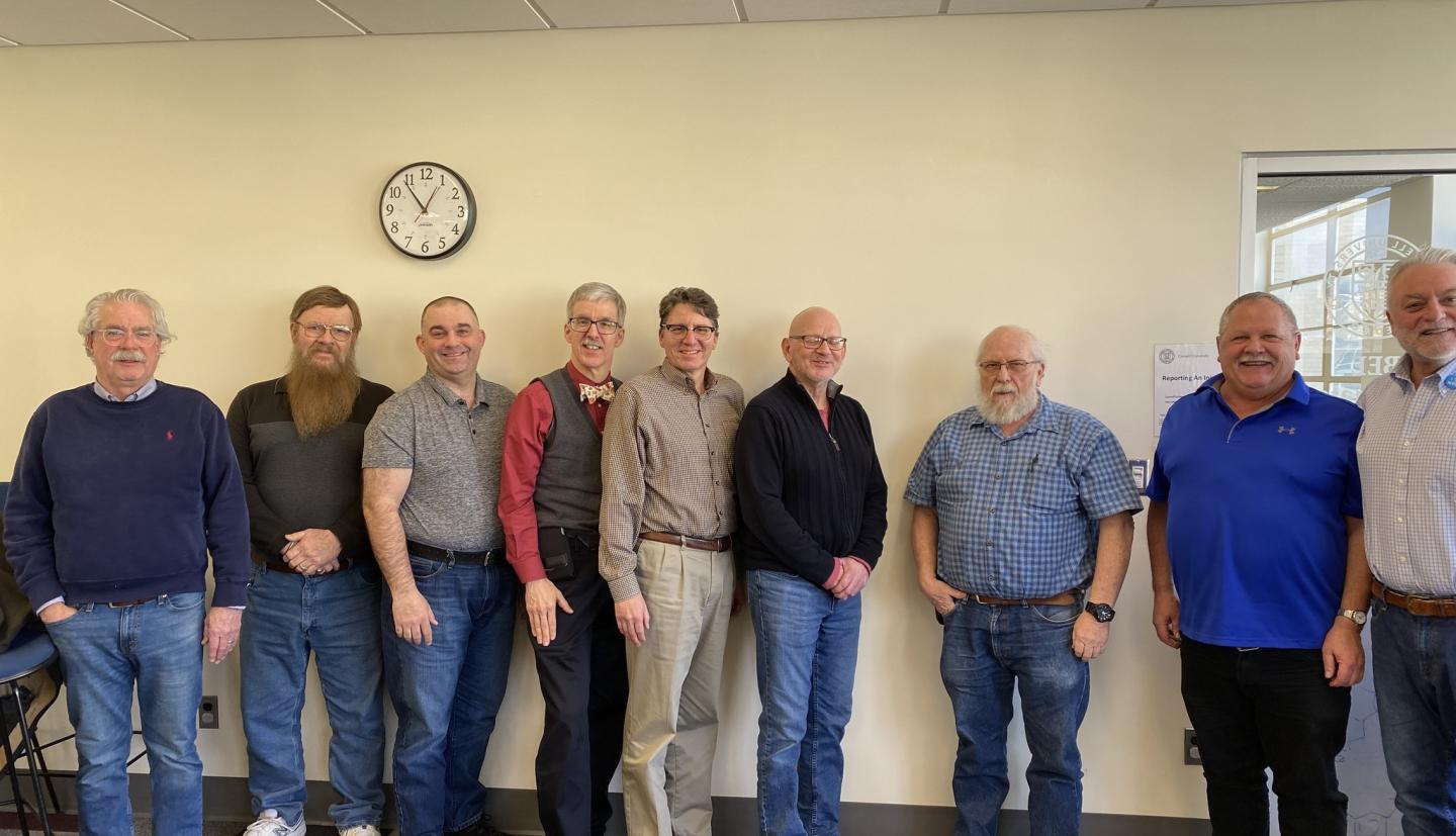 9 people posing for a picture 