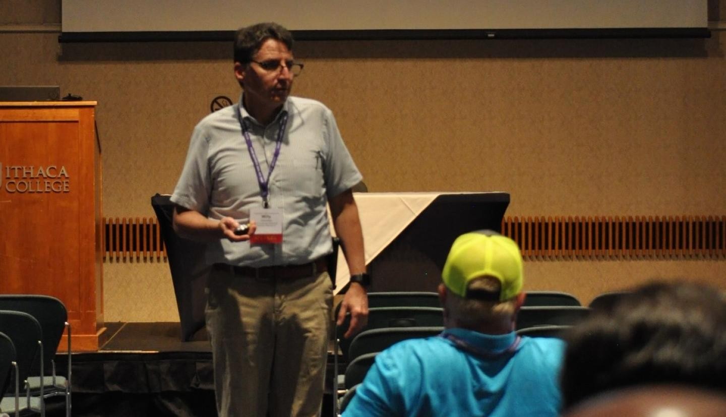 A person standing in front of a group giving a presentation